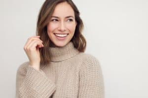 AdobeStock 497022441 - Viera Dental Arts | Dentist in Melbourne FL Portrait of young happy beautiful woman smiling and standing iso